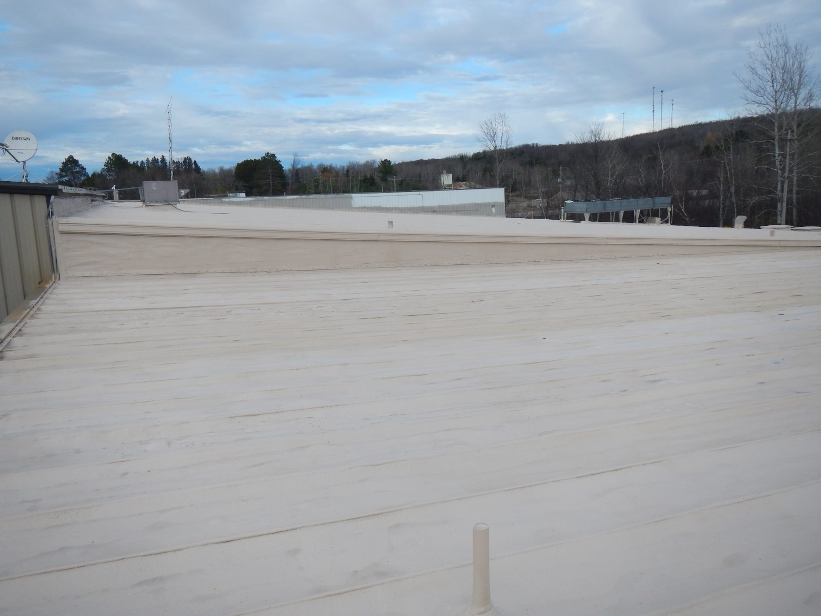 Standing seam metal roof with polyurea membrane